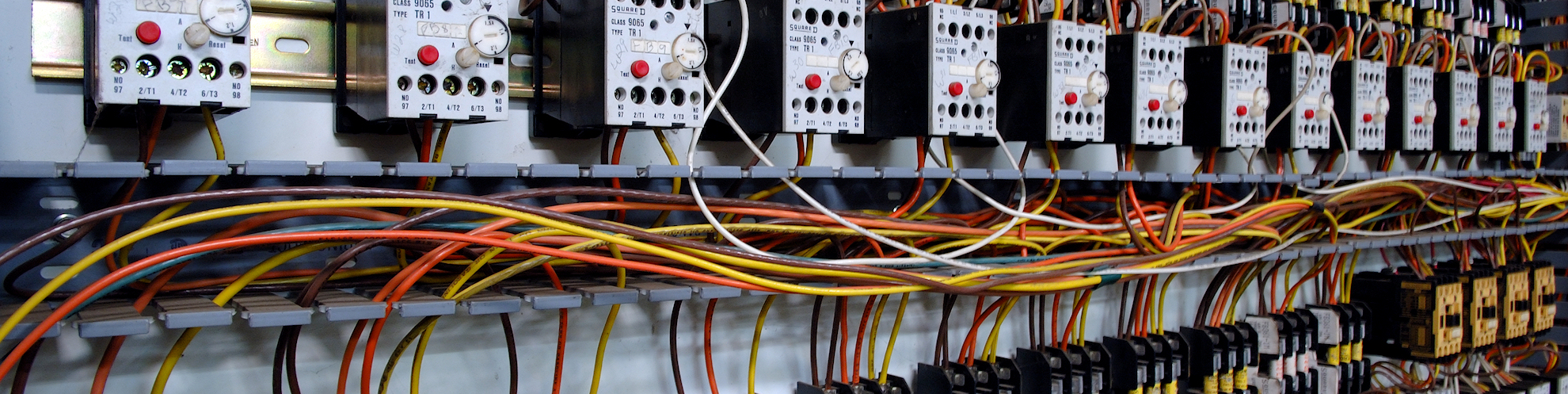 Electrical wiring panel at a assembly line factory. Controls and switches.