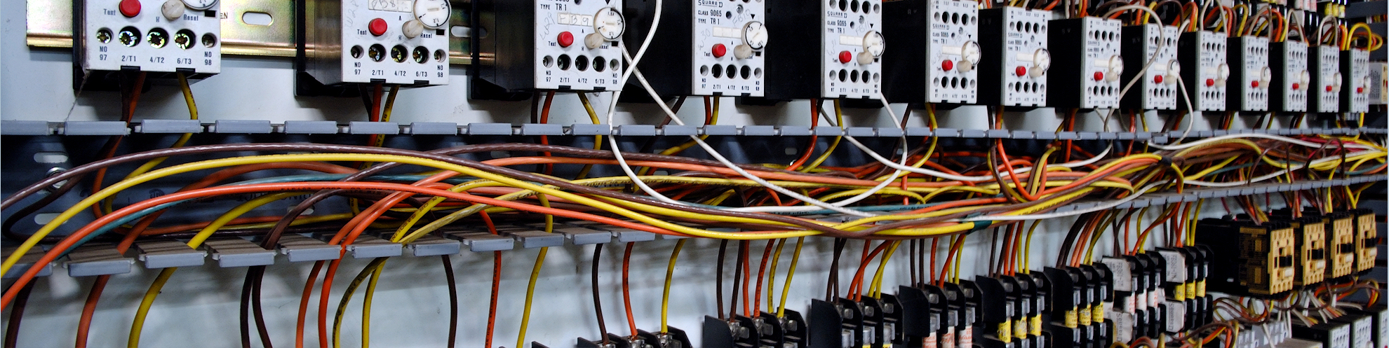Electrical wiring panel at a assembly line factory. Controls and switches.